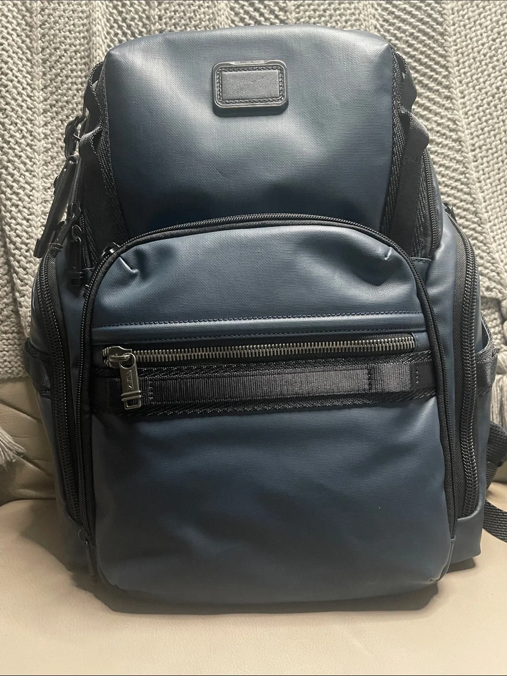 Tumi Men's Blue Travel Backpack with Front Zip Pocket.  It has never been used